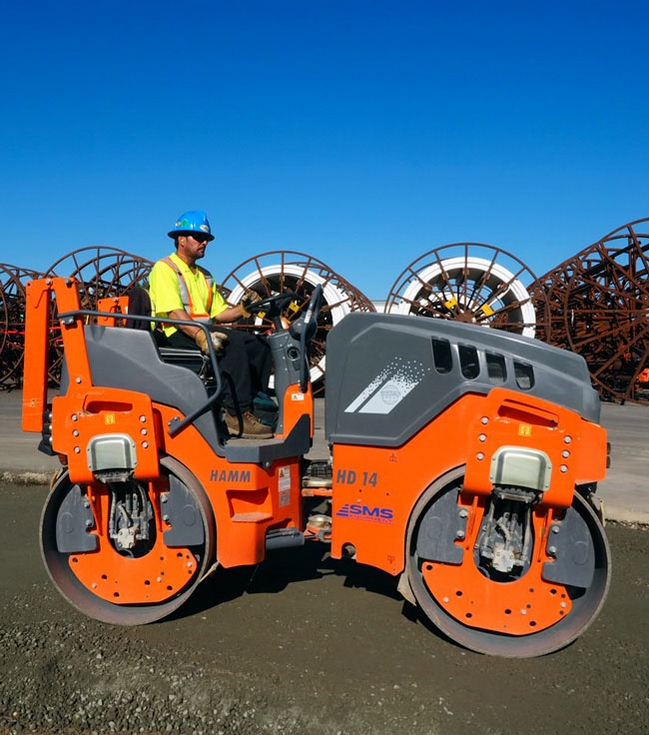 Photo of heavy-duty roller working on compacted concrete.